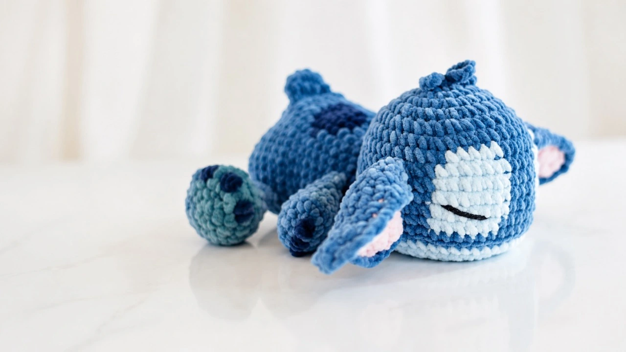 Finished Sleepy Stitch crochet amigurumi in blue plush yarn with embroidered closed eyes, floppy ears, navy claws, and a curled tail.
